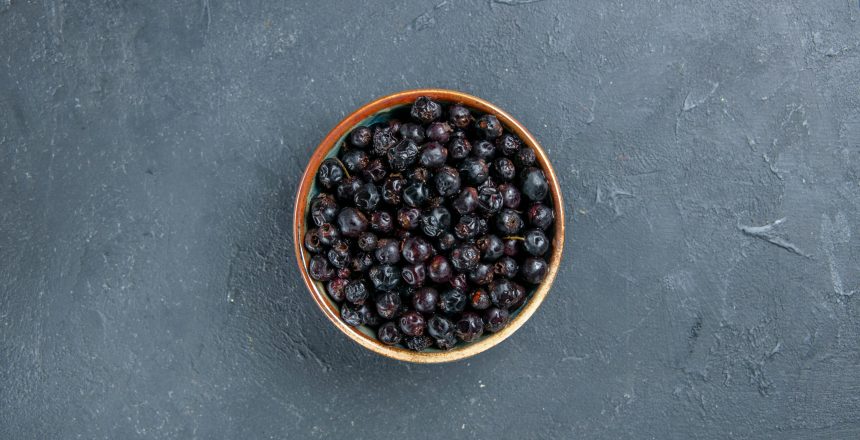 top-view-black-currant-dark-surface-free-space